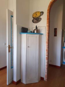 una stanza con un armadietto bianco e una pentola sul muro di Appartamento Guardastelle Holiday House a Rapallo