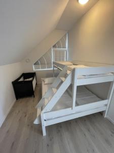 a room with two bunk beds in a attic at Strandferie på Sørlandet in Kristiansand