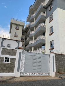 a large apartment building with a gate in front of it at Rorot 2 bdrm stay located Annex home away(bright) in Eldoret