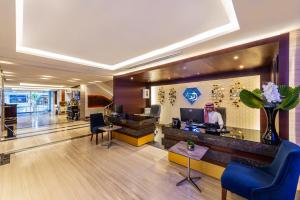 a lobby of an office with a woman sitting at a desk at Blue Diamond Hotel in Jeddah