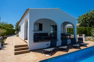 a villa with a swimming pool and a house at Villas Finesse By MENORCARENTALS in Son Bou