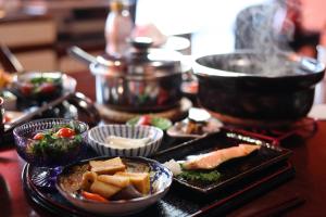 a table topped with dishes of food on a table at Lien Tono in Tōno +19 photos