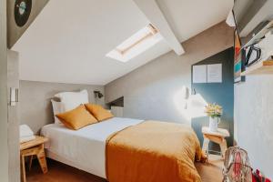 Postel nebo postele na pokoji v ubytování Hôtel Taggât