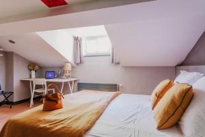 Postel nebo postele na pokoji v ubytování Hôtel Taggât