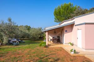 a house with a patio and a yard at Matija in Ližnjan