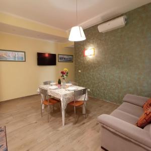 a living room with a table and a couch at Piazza Mazzini 21 in Loano