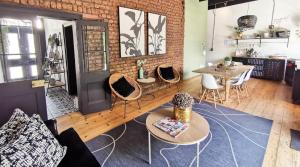 a room with tables and chairs and a brick wall at House of Pinardt in Robertson