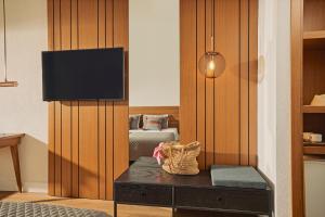 Habitación con dormitorio y TV en la pared. en TUI MAGIC LIFE Sarigerme en Sarigerme
