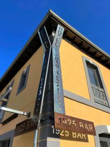 a sign on the side of a building with street signs at Hotel Cadario 1925 in Tebongo +16 photos