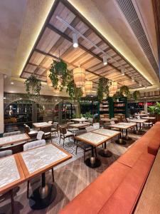 a restaurant with tables and chairs and a large window at Hotel Morione & Spa Center in Istanbul