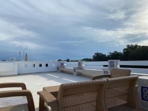 a patio with chairs on a roof at Marsa Authentic Luxury Appart 1 in La Marsa