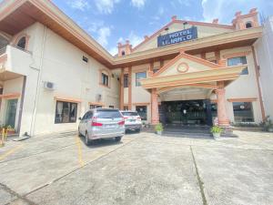 a hotel with a car parked in a parking lot at Lilianto Hotel Polewali Mitra RedDoorz in Campalagiang
