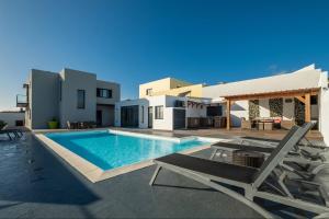 a villa with a swimming pool and a patio at Casa Celeste - Deluxe Ocean View/Heated Pool in Ponta Garça