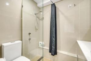 a bathroom with a toilet and a glass shower at Bright 1 Bedroom unit in the heart of Manly in Sydney