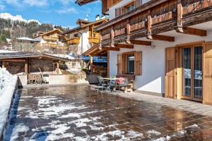 a patio of a house with snow on the ground at Cima Dodici A Parte in Soraga