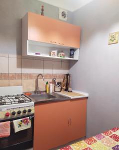 a kitchen with a sink and a stove at 3-х комнатная квартира по улице Коцюбинского, дом 9 дробь 6 in Kremenchuk