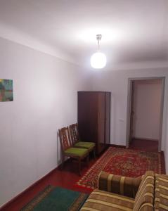 a living room with a couch and a chair at 3-х комнатная квартира по улице Коцюбинского, дом 9 дробь 6 in Kremenchuk