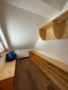 een zolderkamer met houten kasten en houten vloeren bij Apartma LD Puščava in Lovrenc na Pohorju