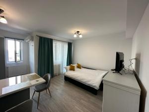 a small room with a bed and a television at Renting Solutions Q in Iaşi