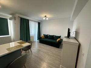 a living room with a couch and a table at Renting Solutions Q in Iaşi