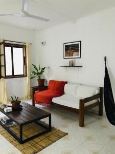 a living room with a couch and a table at Bright Apartment Close to the Beach & City Center in Praia