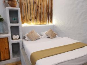 Un pat sau paturi într-o cameră la Achalaa Resort
