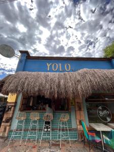 a yoda restaurant with chairs and tables in front of it at Yolo Hostel Medellin in Medellín
