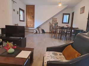 a living room with a couch and a table at Casa Champasak in Órgiva