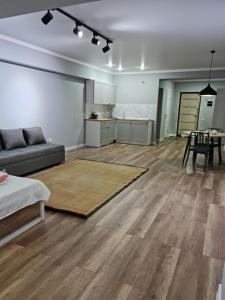 a large living room with a couch and a table at Апартаменты в центре, в новом доме in Almaty