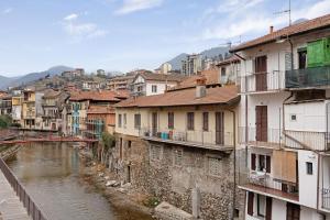 a group of buildings and a river in a city at Casa Giola Omegna in Omegna