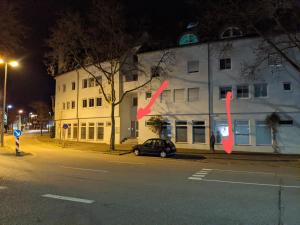 a car parked in front of a building at night at Cozy Apartment with Parking Garage near Outlet in Metzingen