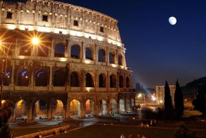 a view of the coliseum at night at Vatican Cozy Suites - Liberty Collection in Rome