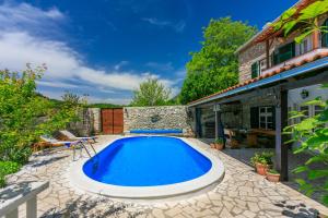 a swimming pool in the backyard of a house at Santa Barbara in Drivenik +63 photos