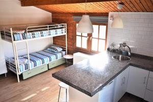 a kitchen with a bunk bed and a counter top at Kontiki Bungalows El Palmar in El Palmar