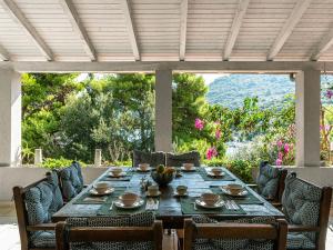 a table and chairs on a patio with a view at Villa Angela in Lastovo