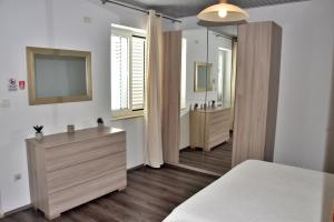 a bathroom with a sink and a mirror at Apartments Aurelia in Dubrovnik