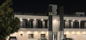 a building with cars parked in front of it at night at Amazing apartment in Riyadh