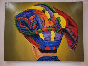 a painting of a person wearing a colorful hat at Sleep Walker Poshtel in Chiang Mai