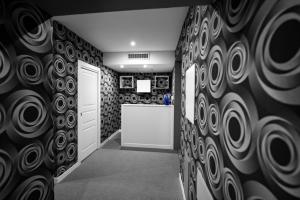 a hallway with black and white walls and a door at Sole Luxury Bed and Breakfast in Naples