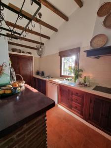 a large kitchen with wooden cabinets and a counter top at Casa Antonia in Algarrobo