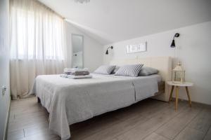 Posteľ alebo postele v izbe v ubytovaní Apartments Up&Up