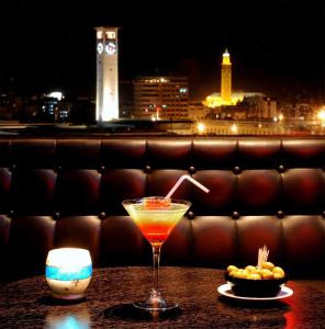 a drink sitting on a table with a view of a city at Washington Hotel in Casablanca