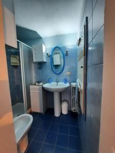 a bathroom with a sink and a toilet and a mirror at Villa Tutti i colori del Chianti in Linari