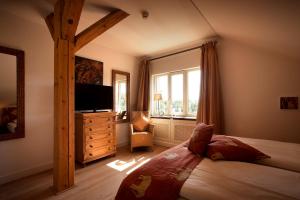 a bedroom with a bed and a large window at Gerber Park Hotel in Uhingen