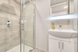 a bathroom with a shower and a sink at Boutique Living by Lawsons in Windsor