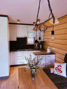 a kitchen with a vase of flowers on a table at Domki u Danki in Brenna