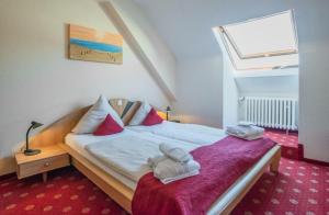 a bedroom with a bed with towels on it at Park Hotel in Konz