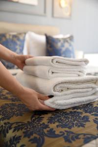 een stapel handdoeken bovenop een bed bij 12 rooms hotel in Köseilyas