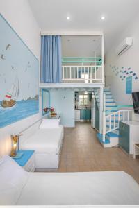 a bedroom with a bunk bed and a staircase at Haraki Mare Studios beach front in Haraki