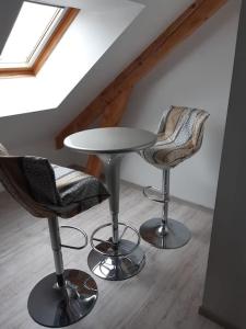 a table and two chairs in a room at Petit appartement à la campagne proche mer in Missillac